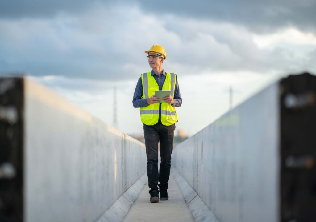 Male engineer working with tablet at construction site.